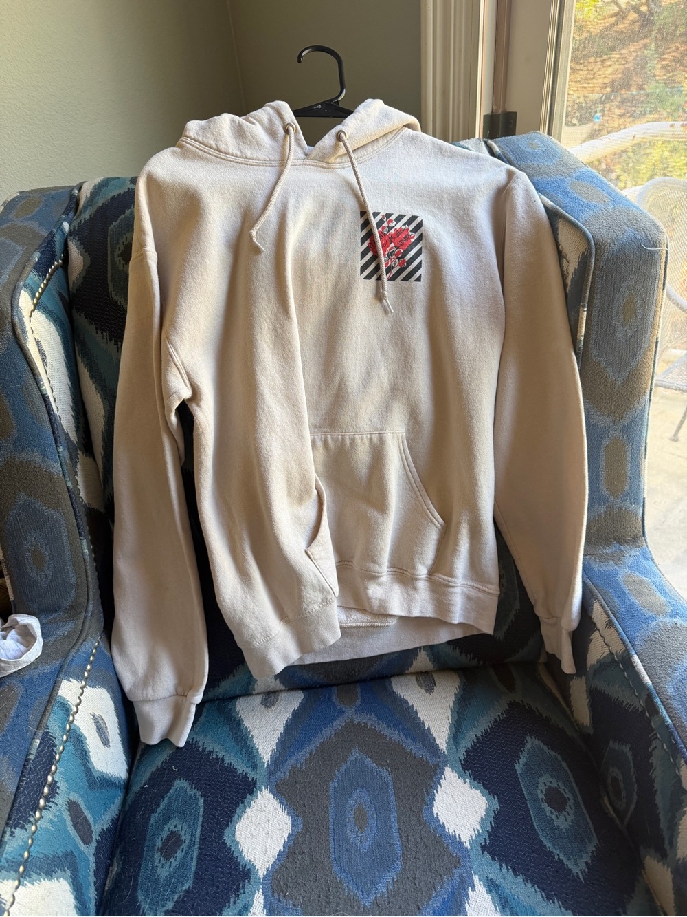 Neutral Cream Pullover Hoodie with Small Red Chest Graphic